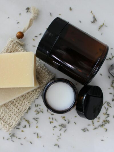 A flat lay featuring soap, cream, and essential oils for a luxurious skincare ritual.