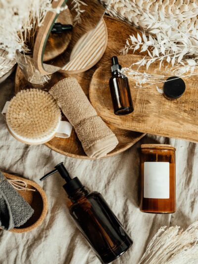 Aesthetic arrangement of natural skincare products and accessories on a wooden tray.