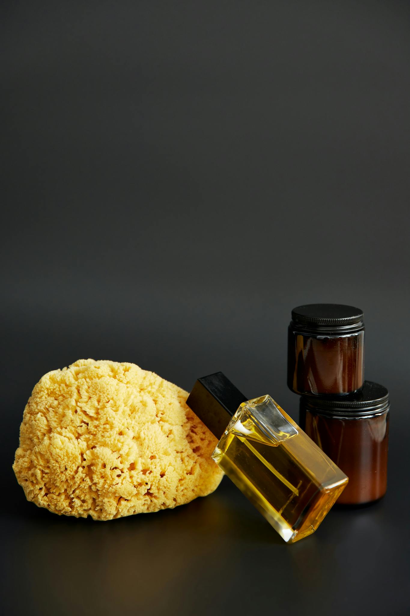 Sophisticated arrangement of natural skincare products on a sleek black background, perfect for self-care.